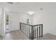 Bright foyer with fresh white walls, modern light fixture, wood-look flooring, and staircase at 610 E Montebello Ave # 46, Phoenix, AZ 85012