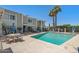 Community pool with lounge chairs, lush landscaping, and condo buildings at 610 E Montebello Ave # 46, Phoenix, AZ 85012