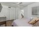 Well-lit bedroom with wood floors, ceiling fan, and spacious closet at 6940 E Cochise Rd # 1027, Paradise Valley, AZ 85253
