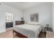 Cozy bedroom with wood floors, a ceiling fan, and a view into an en-suite bathroom at 6940 E Cochise Rd # 1027, Paradise Valley, AZ 85253