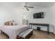 Tranquil bedroom with ceiling fan, wood floors, TV, dresser, and accent bench at 6940 E Cochise Rd # 1027, Paradise Valley, AZ 85253