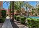 Community pool and lounge area surrounded by lush landscaping and tall palm trees at 6940 E Cochise Rd # 1027, Paradise Valley, AZ 85253