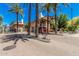 Community entrance with manicured landscape and tall palm trees at 6940 E Cochise Rd # 1027, Paradise Valley, AZ 85253