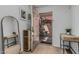 Inviting entryway with wood floors, stylish mirror, and a glimpse of the private patio at 6940 E Cochise Rd # 1027, Paradise Valley, AZ 85253