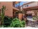 Charming condo exterior features a private entrance with stone accents and lush landscaping at 6940 E Cochise Rd # 1027, Paradise Valley, AZ 85253