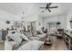 Open-concept living room with plush sofa, ceiling fan, hardwood floors and natural light at 6940 E Cochise Rd # 1027, Paradise Valley, AZ 85253