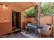 Private patio with cozy seating, a stone pillar, and access to the home's interior at 6940 E Cochise Rd # 1027, Paradise Valley, AZ 85253