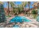 Community pool and spa surrounded by palm trees and lounge chairs in a resort-style setting at 6940 E Cochise Rd # 1027, Paradise Valley, AZ 85253