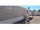 Charming manufactured home with desert landscaping, vibrant pink flamingo, and bright blue sky at 730 S Country Club Dr # 81, Mesa, AZ 85210