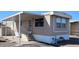 Inviting manufactured home featuring covered entry, tidy landscaping, and neutral color palette at 730 S Country Club Dr # 81, Mesa, AZ 85210