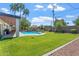 Expansive backyard featuring a sparkling pool, green grass and lush landscaping at 735 E Northern Ave, Phoenix, AZ 85020