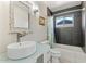 Well lit bathroom featuring a modern vessel sink, a decorative mirror and a tiled shower and bathtub at 735 E Northern Ave, Phoenix, AZ 85020