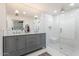 Elegant bathroom with a double vanity, walk-in shower, and modern finishes at 735 E Northern Ave, Phoenix, AZ 85020