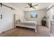 Serene bedroom with white bed frame, sliding barn doors and a view to the outside at 735 E Northern Ave, Phoenix, AZ 85020