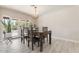 Cozy dining area with wooden table, chandelier, and patio doors leading to a pool at 735 E Northern Ave, Phoenix, AZ 85020
