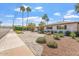 Inviting front yard featuring lush landscaping, a brick driveway, and a well-maintained white brick home at 735 E Northern Ave, Phoenix, AZ 85020