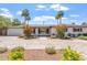Charming single-story home with a well-manicured yard, brick driveway, and colorful shrubbery at 735 E Northern Ave, Phoenix, AZ 85020