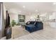 Bright living room with a fireplace, an open floor plan, tile floors, and a modern couch at 735 E Northern Ave, Phoenix, AZ 85020