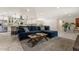 Cozy living room featuring a comfortable sofa, modern decor, and an open view into the kitchen at 735 E Northern Ave, Phoenix, AZ 85020