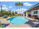 Backyard showcasing a sparkling pool, comfortable seating, lush landscaping and tall palm trees at 735 E Northern Ave, Phoenix, AZ 85020