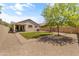 Backyard featuring artificial grass, desert landscaping and a brick patio with a covered patio area at 812 S Fern Ct, Gilbert, AZ 85296