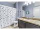 Well-lit bathroom showcasing granite countertops, a shower with curtain, and neutral walls at 812 S Fern Ct, Gilbert, AZ 85296