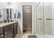 Neutral bathroom featuring a glass shower, granite countertops and a decorative mirror for a relaxing and stylish atmosphere at 812 S Fern Ct, Gilbert, AZ 85296