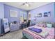 Stylish bedroom with a large window, carpet flooring, playful purple walls, and plenty of space at 812 S Fern Ct, Gilbert, AZ 85296