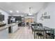 Bright dining area with a ceiling fan, a large window, tile floors and bar seating at 812 S Fern Ct, Gilbert, AZ 85296