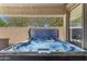 Hot tub installed with a cover, offering a relaxing experience under a covered patio, enhanced by surrounding landscaping at 812 S Fern Ct, Gilbert, AZ 85296