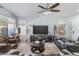 Comfortable living room with plush seating, a ceiling fan, large windows, and neutral paint at 812 S Fern Ct, Gilbert, AZ 85296