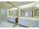 This well-lit bathroom includes a large mirror and generous vanity with storage at 839 S Westwood -- # 170, Mesa, AZ 85210