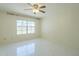 Bright bedroom with tile floors, ceiling fan, and a large window letting in natural light at 839 S Westwood -- # 170, Mesa, AZ 85210