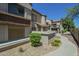 Condo exterior showing well maintained landscaping, community walkway, and stucco facade at 839 S Westwood -- # 170, Mesa, AZ 85210