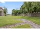 A lush green common area featuring manicured lawns, shade trees, and landscape rocks at 839 S Westwood -- # 170, Mesa, AZ 85210