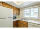 Convenient kitchen setup with wooden cabinets, essential appliances, and a practical layout for meal preparation at 839 S Westwood -- # 170, Mesa, AZ 85210