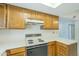 Well-equipped kitchen area showcasing wood cabinetry, sleek appliances, and a comfortable cooking space at 839 S Westwood -- # 170, Mesa, AZ 85210