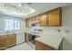 Cozy kitchen featuring wood cabinetry, a double basin sink, and modern appliances for easy cooking at 839 S Westwood -- # 170, Mesa, AZ 85210