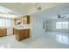 Bright living room and kitchen with tile floors, white walls, ceiling fans, and a skylight to fill with light at 839 S Westwood -- # 170, Mesa, AZ 85210