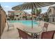 Community pool area with lounge chairs, tables, and shade, surrounded by the complex buildings at 839 S Westwood -- # 170, Mesa, AZ 85210