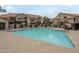 Large community pool surrounded by lounge chairs and landscaping in a well-maintained apartment complex at 839 S Westwood -- # 170, Mesa, AZ 85210