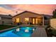 Enjoy this beautiful backyard with a sparkling pool, covered patio, and landscaped yard for outdoor living at 9013 E Shooting Star Dr, Gold Canyon, AZ 85118
