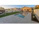 Beautiful backyard pool with a putting green, patio, and meticulous landscaping offers resort-style living at 9013 E Shooting Star Dr, Gold Canyon, AZ 85118