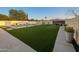 Expansive backyard with a sparkling pool, lush turf, and vibrant landscaping for outdoor enjoyment at 9013 E Shooting Star Dr, Gold Canyon, AZ 85118