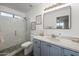 Bathroom with a glass-enclosed shower, framed art, and stylish blue vanity at 9013 E Shooting Star Dr, Gold Canyon, AZ 85118