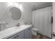 Bathroom with a round mirror, shower with a curtain, and a gray vanity at 9013 E Shooting Star Dr, Gold Canyon, AZ 85118