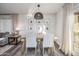 Cozy dining area featuring a modern light fixture, gallery wall, and glass doors to outdoor space at 9013 E Shooting Star Dr, Gold Canyon, AZ 85118