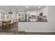 Bright kitchen with stainless steel appliances, dark counters, and modern white cabinets and an adjacent dining area at 9013 E Shooting Star Dr, Gold Canyon, AZ 85118