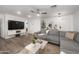 Inviting living room features a large sectional sofa, modern ceiling fan and sleek entertainment center at 9013 E Shooting Star Dr, Gold Canyon, AZ 85118