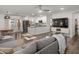 Open-concept living room with a modern ceiling fan, seamlessly connecting to the kitchen and dining area at 9013 E Shooting Star Dr, Gold Canyon, AZ 85118